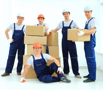 Staff preparing labelled boxes and furniture for an office move