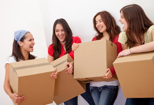 Local removals team helping with furniture loading in New Malden