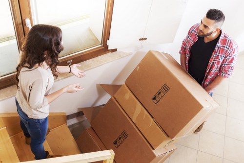 Van loading donations and reusable furniture for charity partnerships in New Malden