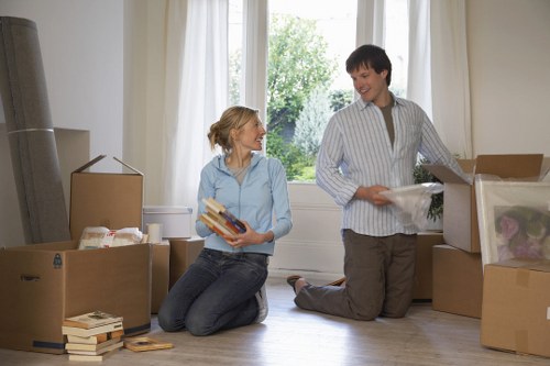 Packed moving boxes and furniture ready for collection in New Malden